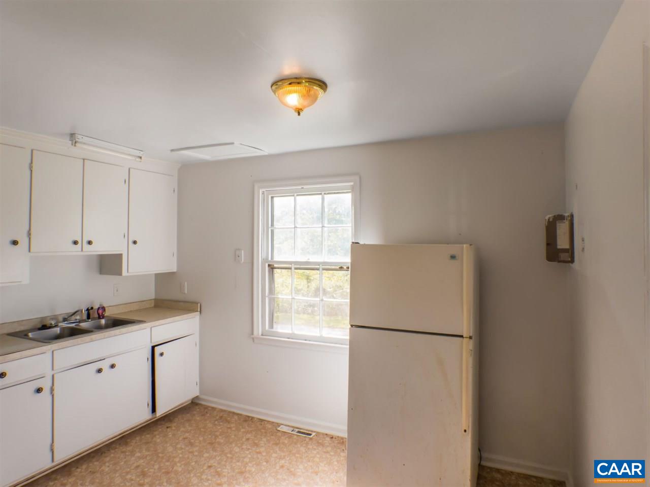 7595 Esmont Road Esmont, VA 22937 - Photo 10 of 30 a kitchen with a refrigerator and window