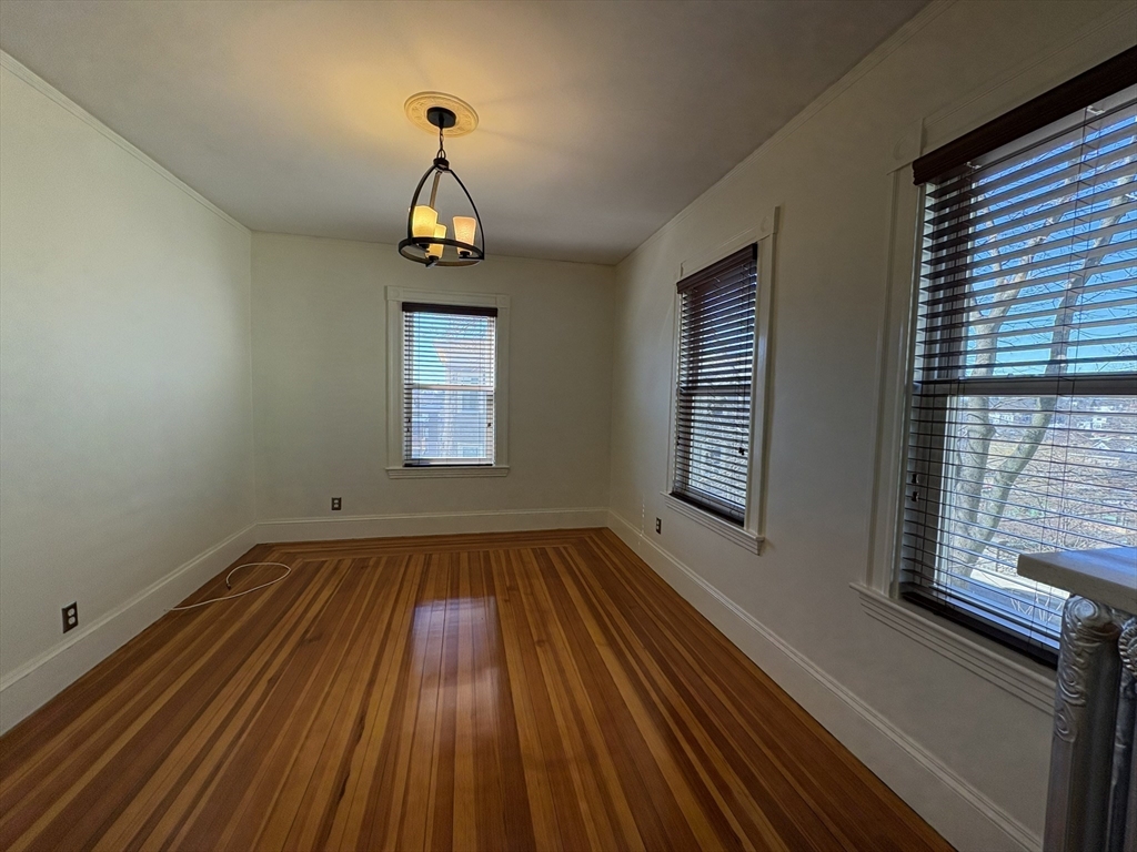 62 Ibbetson Street, Unit 3L Somerville, MA 02143 - Photo 8 of 20 a view of empty room with wooden floor and fan