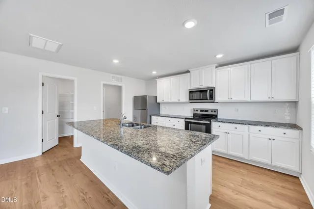 a spacious bedroom with a bed and a couch