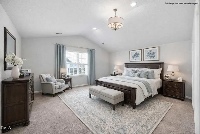 an aerial view of a house with a yard and lake view