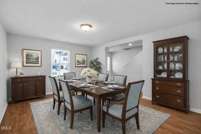 a kitchen with stainless steel appliances granite countertop a sink dishwasher and a stove top oven with wooden floor