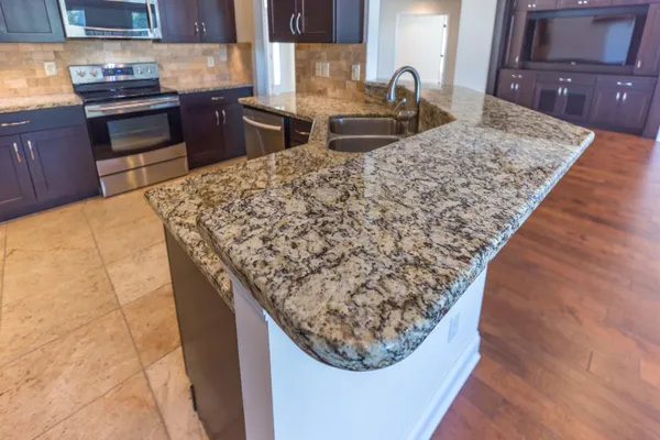 a kitchen with a stove a sink and a refrigerator