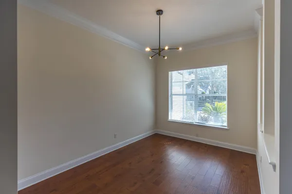 a living room with a wooden floor and a microwave