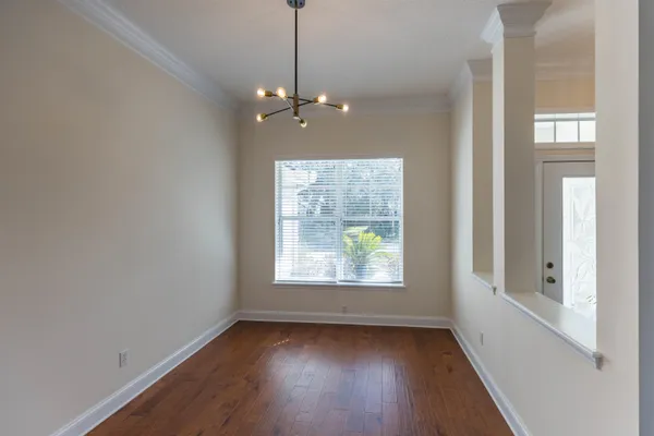 a view of kitchen with kitchen island microwave and wooden floor