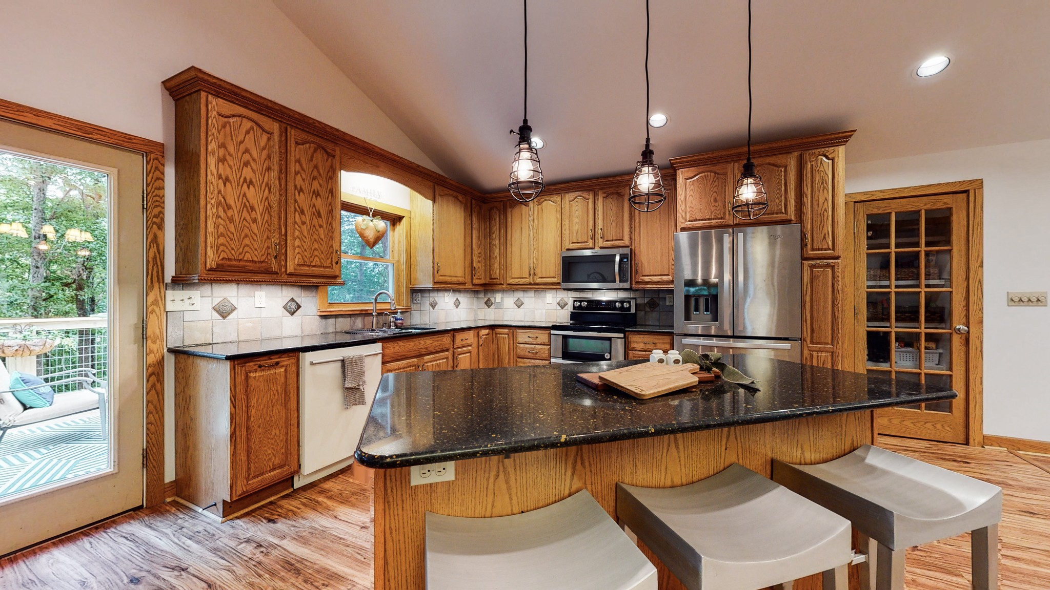 7449 Les Hughes Road Fairview, TN 37062 - Photo 14 of 49 a kitchen with stainless steel appliances granite countertop a stove refrigerator sink microwave and cabinets