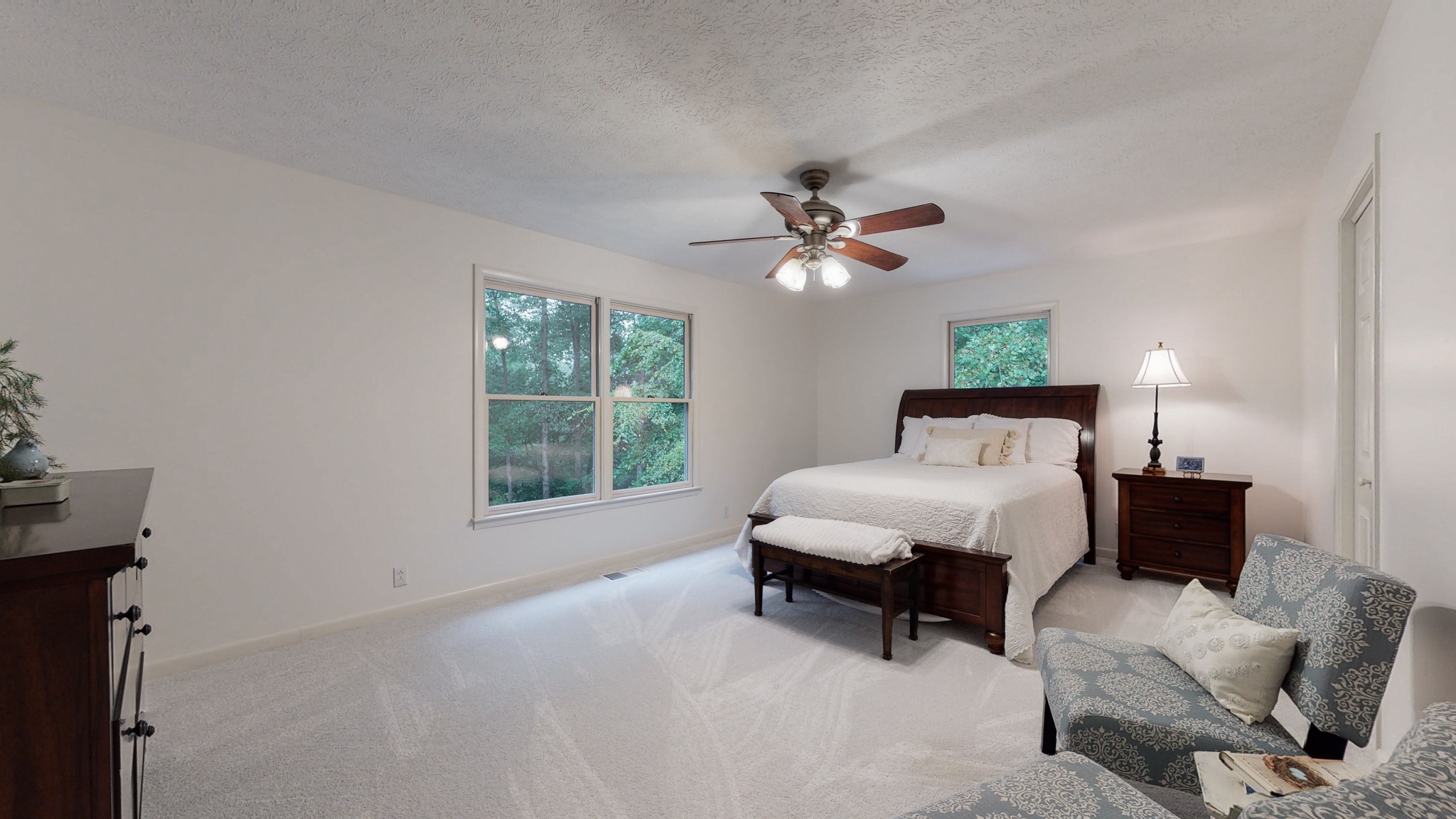 7449 Les Hughes Road Fairview, TN 37062 - Photo 24 of 49 a spacious bedroom with a bed a lamp on table and a window