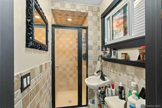 a bathroom with a sink a toilet and a mirror