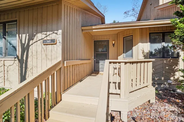 a view of a house with wooden fence