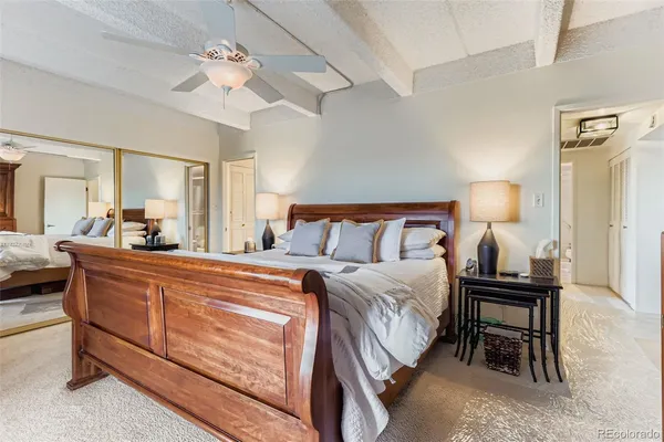 a spacious bedroom with a bed and a chandelier