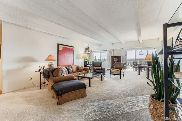 a living room with furniture and a lamp