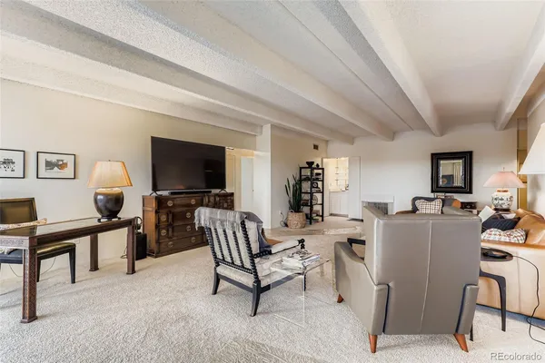 a living room with furniture and a lamp