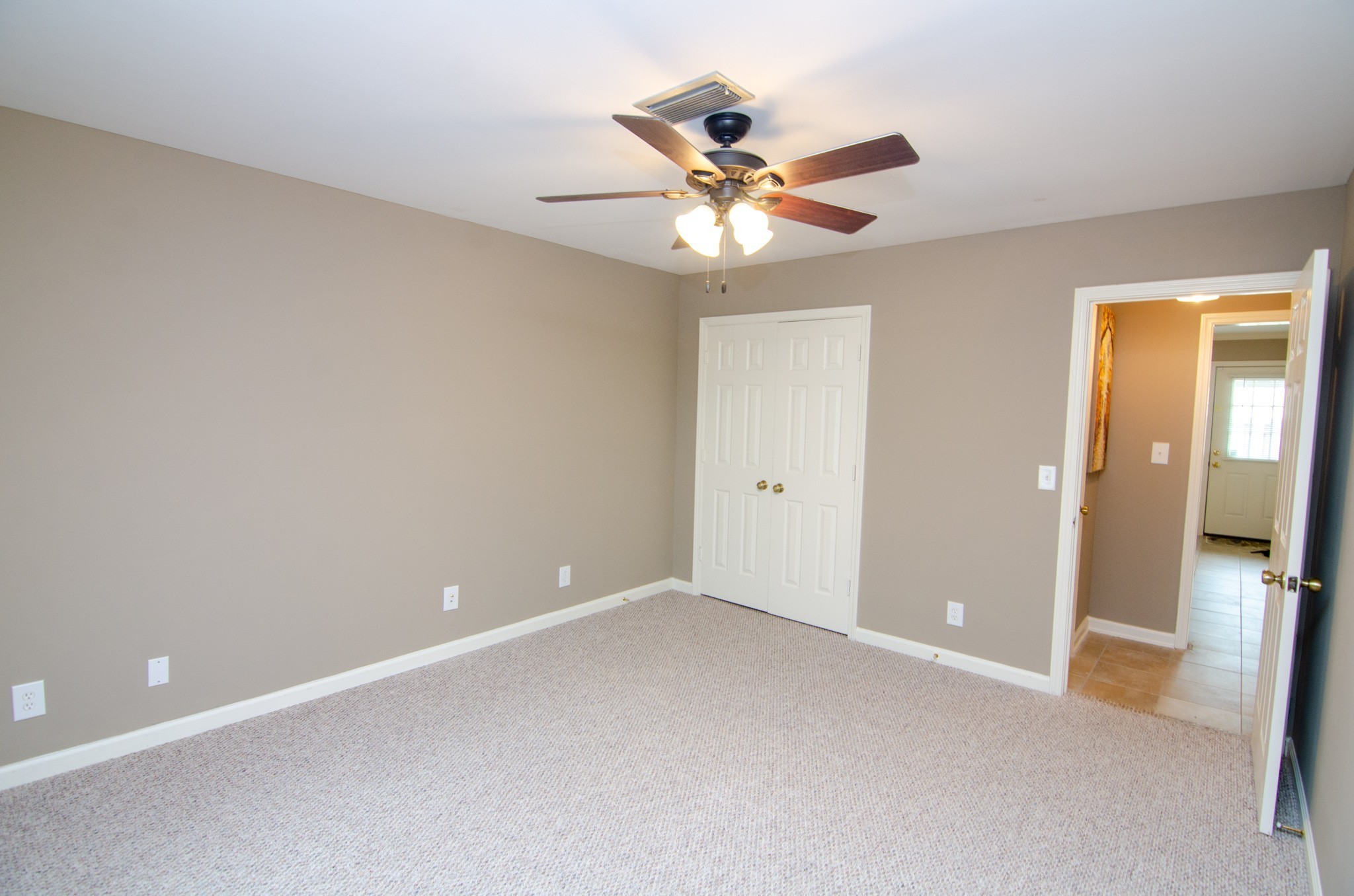 1128 General George Patton Road Nashville, TN 37221 - Photo 11 of 33 a view of an empty room with wooden floor and a ceiling fan