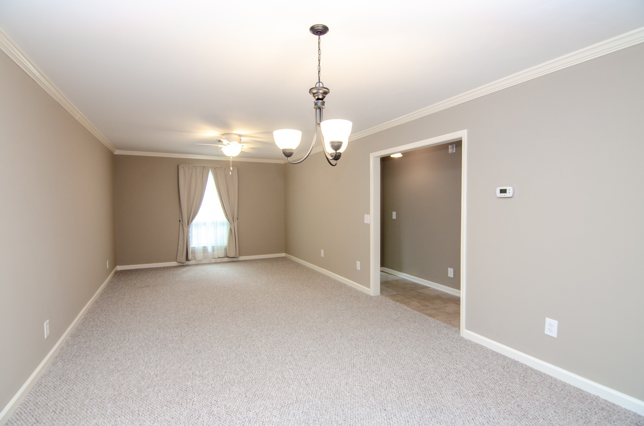 1128 General George Patton Road Nashville, TN 37221 - Photo 13 of 33 a view of an empty room with window and chandelier fan
