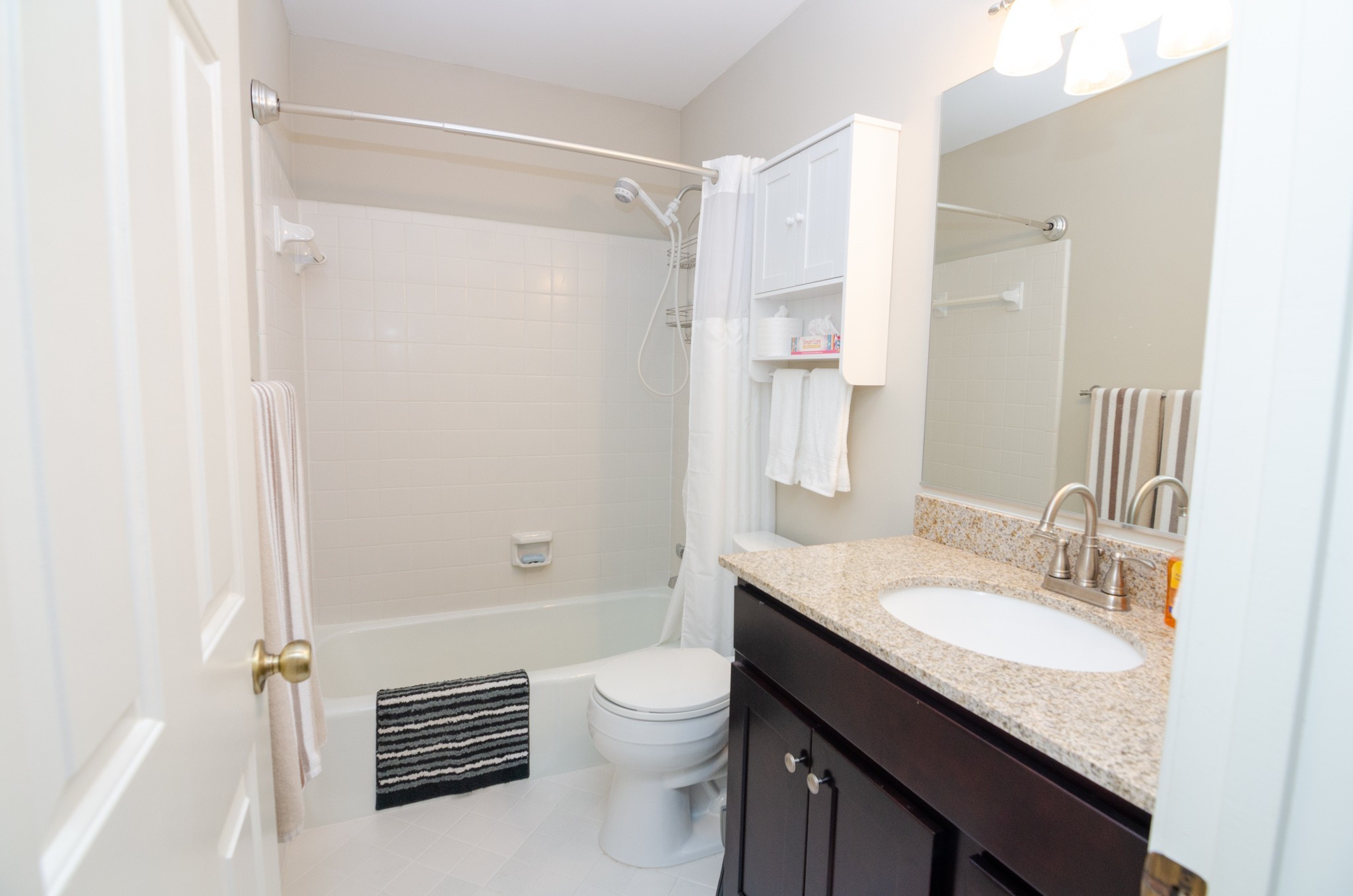 1128 General George Patton Road Nashville, TN 37221 - Photo 18 of 33 a bathroom with a granite countertop sink toilet a mirror and shower