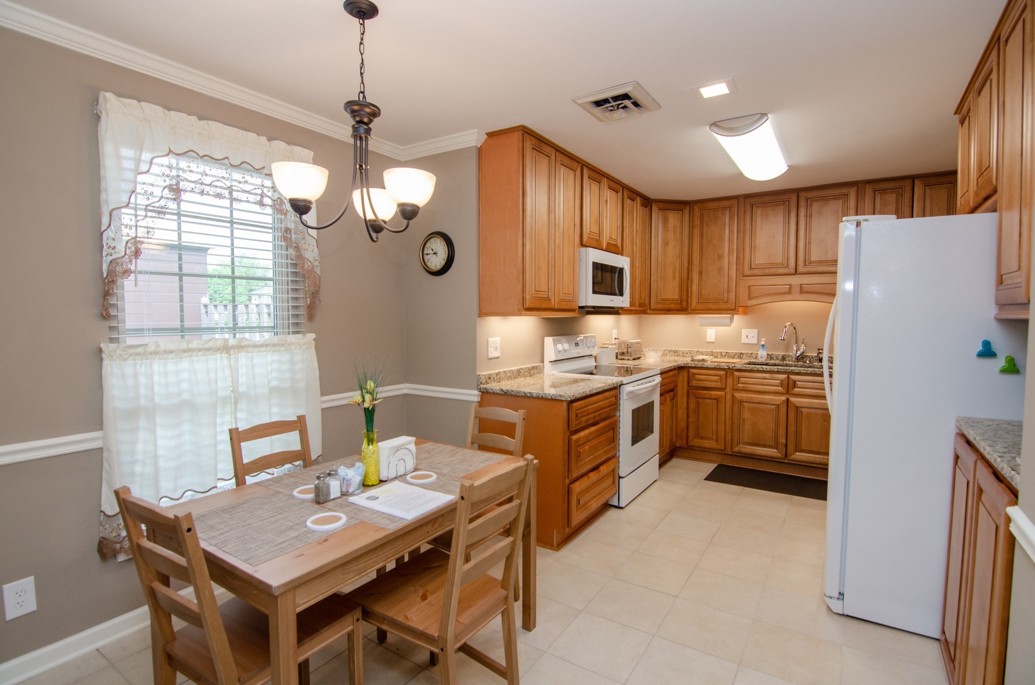 1128 General George Patton Road Nashville, TN 37221 - Photo 5 of 33 a kitchen with a refrigerator a stove a sink dishwasher with a dining table and chairs