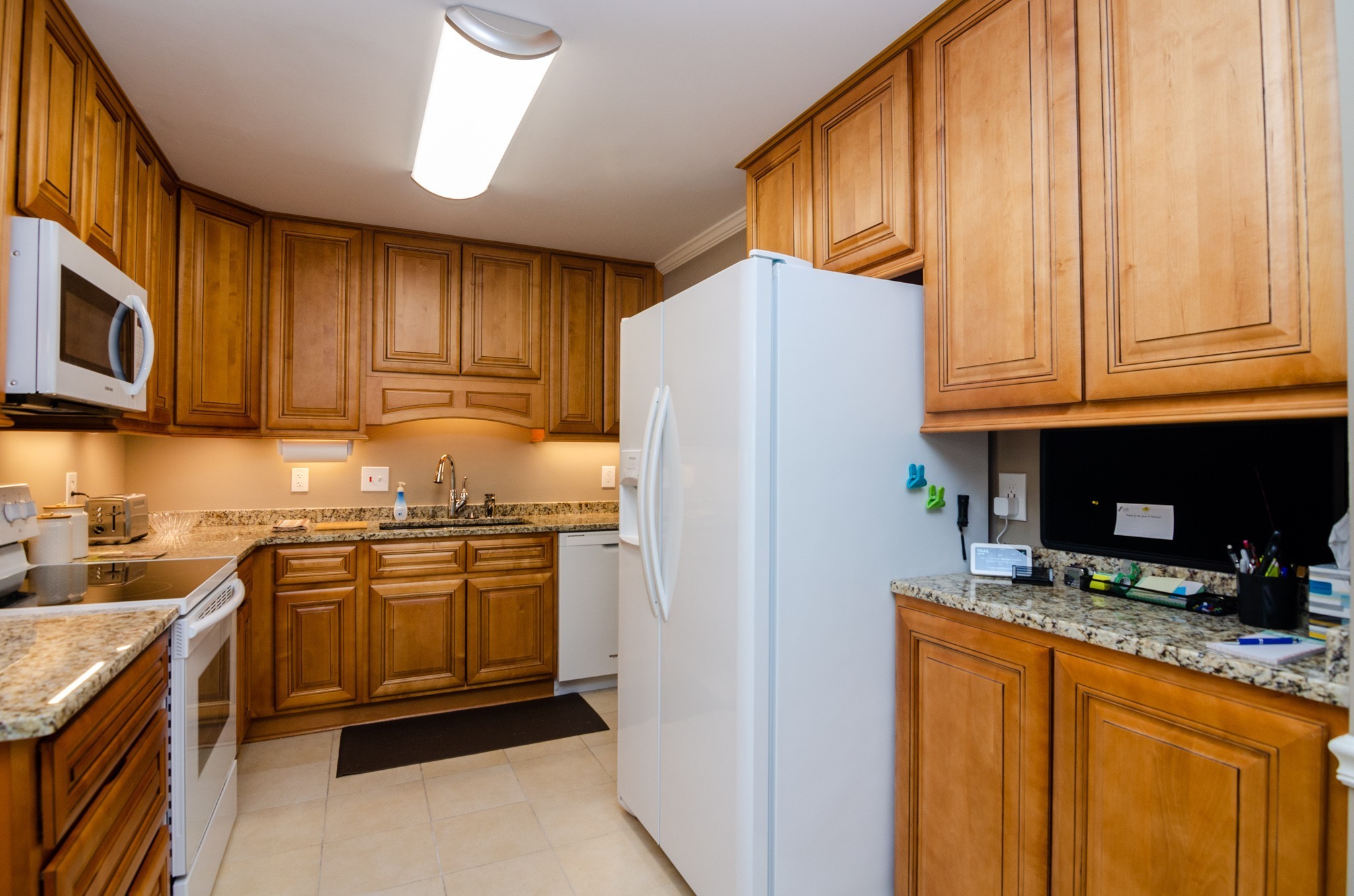 1128 General George Patton Road Nashville, TN 37221 - Photo 6 of 33 a kitchen with stainless steel appliances granite countertop a refrigerator stove and sink