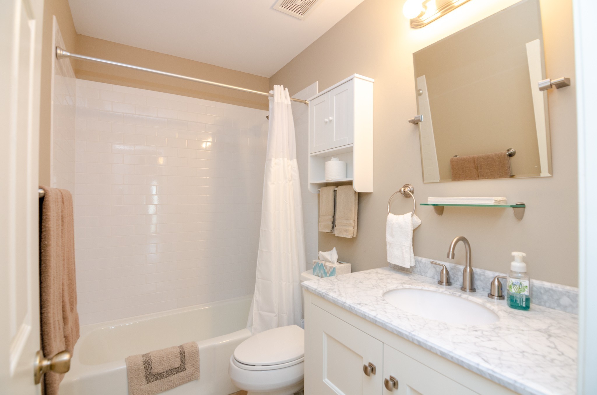 1128 General George Patton Road Nashville, TN 37221 - Photo 9 of 33 a bathroom with a granite countertop sink a toilet and shower