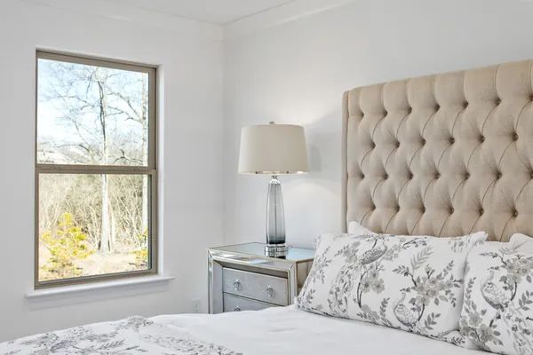 a bedroom with a bed and a window