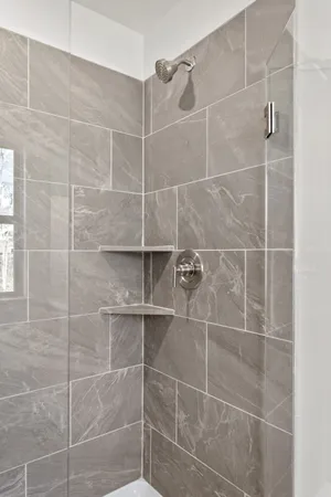 a bathroom with a granite countertop sink a toilet and shower