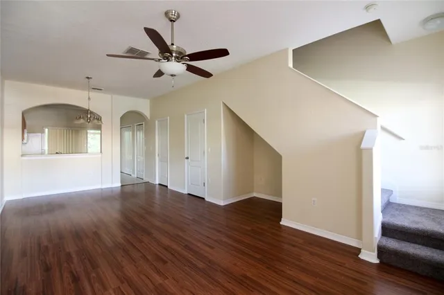 a view of empty room with wooden floor