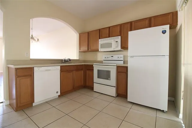 a kitchen with stainless steel appliances a refrigerator sink and cabinets