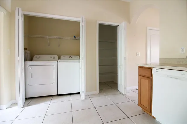 a utility room with cabinets washer and dryer