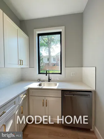 a utility room with a sink a vanity and a window