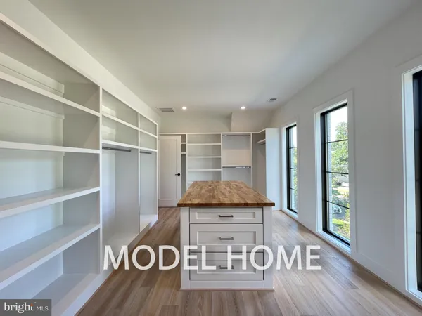 a view of a room with a window and wooden floor