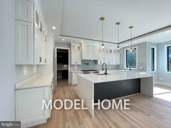 a kitchen with a sink and chairs