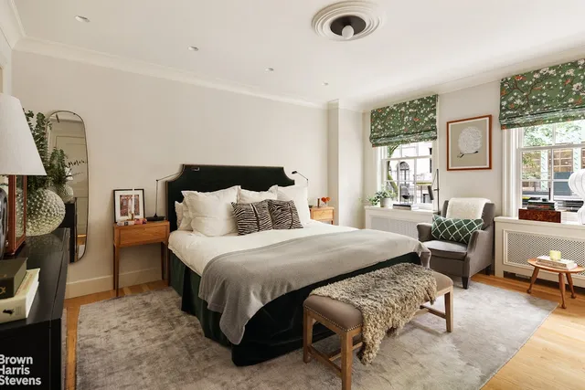 a bedroom with a bed and large window