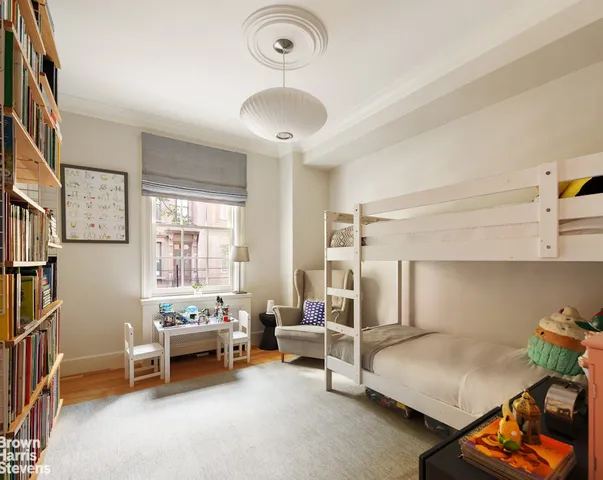 a bedroom with a bed couch and window