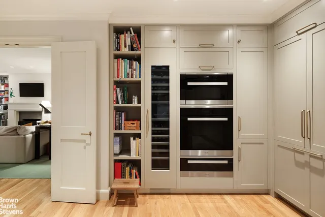 a kitchen with stainless steel appliances granite countertop a table chairs stove and refrigerator