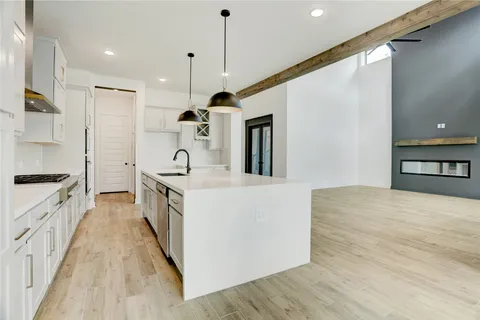 a kitchen with stainless steel appliances a sink a microwave a refrigerator and trees