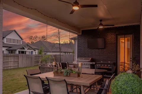 a view of a patio with a table and chairs