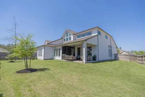 a view of a house with a yard and sitting area