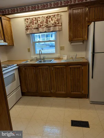 a kitchen with stainless steel appliances a refrigerator and cabinets