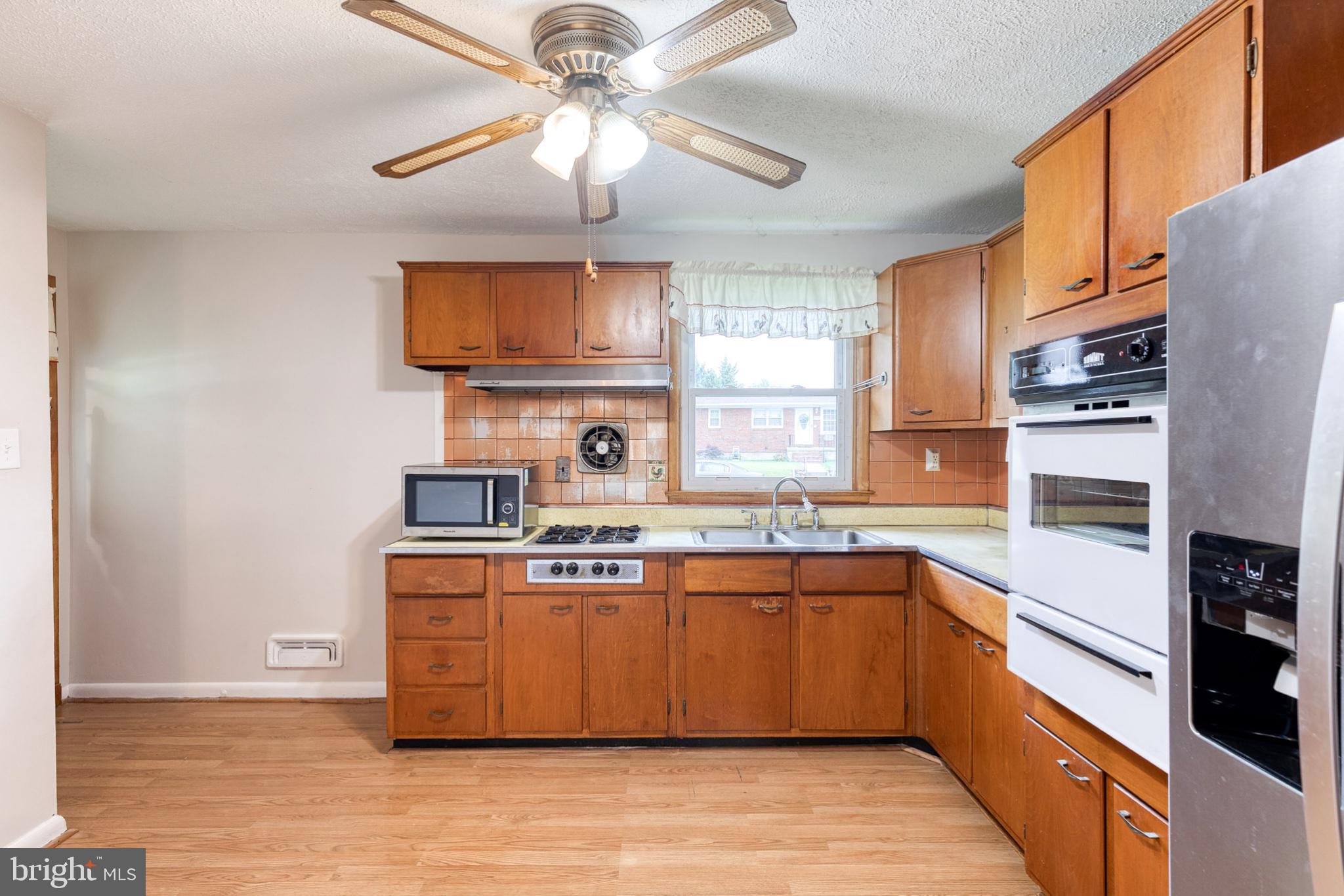 8306 Berkfield Road Baltimore, MD 21237 - Photo 13 of 29 Charming kitchen with classic wood accents.