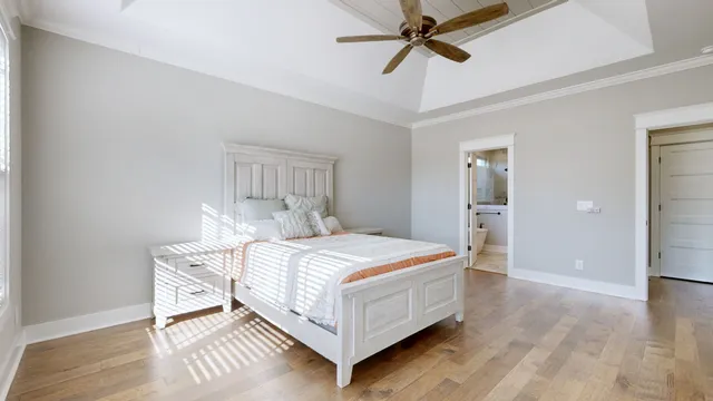 a bed sitting in a bedroom next to a window