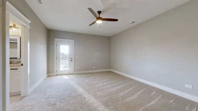 a view of an empty room with a ceiling fan