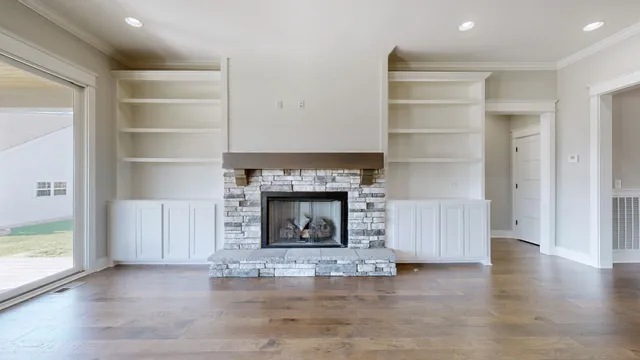 a living room with a fireplace and a wooden floor