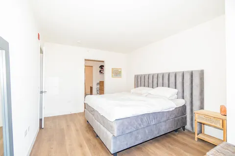 a large white bed in a white room