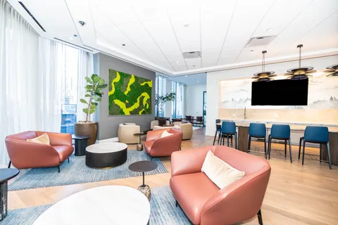 a living room with furniture a rug and a flat screen tv