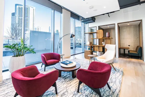 a living room with furniture and a potted plant