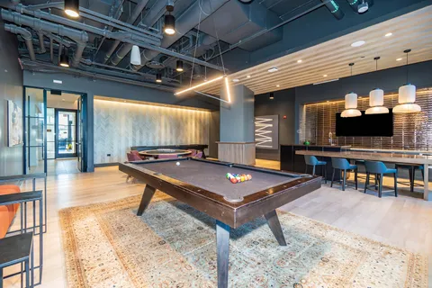 a room with furniture and pool table