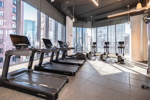 a living room with patio furniture and floor to ceiling window