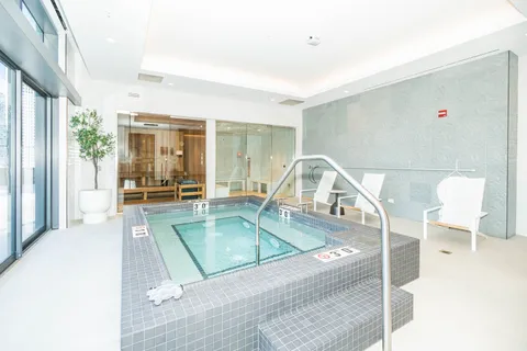 a view of a living room with a floor to ceiling window and couch