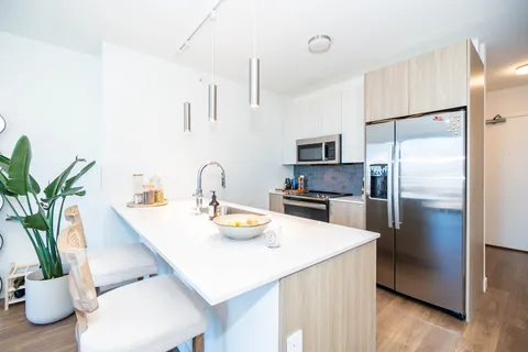 a kitchen with a refrigerator and a sink