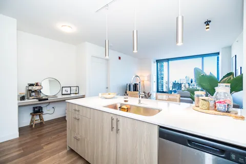 a kitchen with sink refrigerator and stove