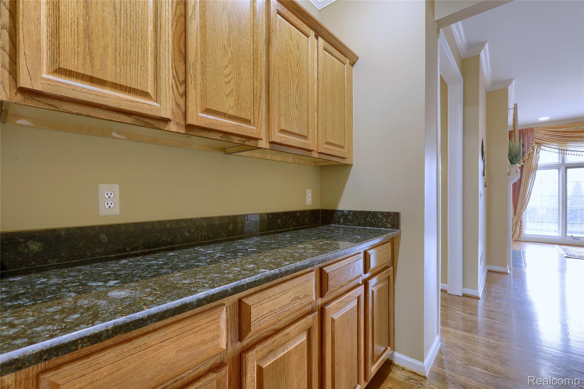 2007 Mapleridge Road Rochester, MI 48309 - Photo 10 of 45 Kitchen with ornamental molding, dark stone countertops, wood finished floors, and recessed lighting