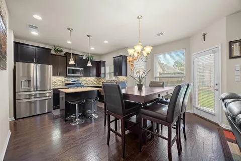 a view of a house with swimming pool and sitting area